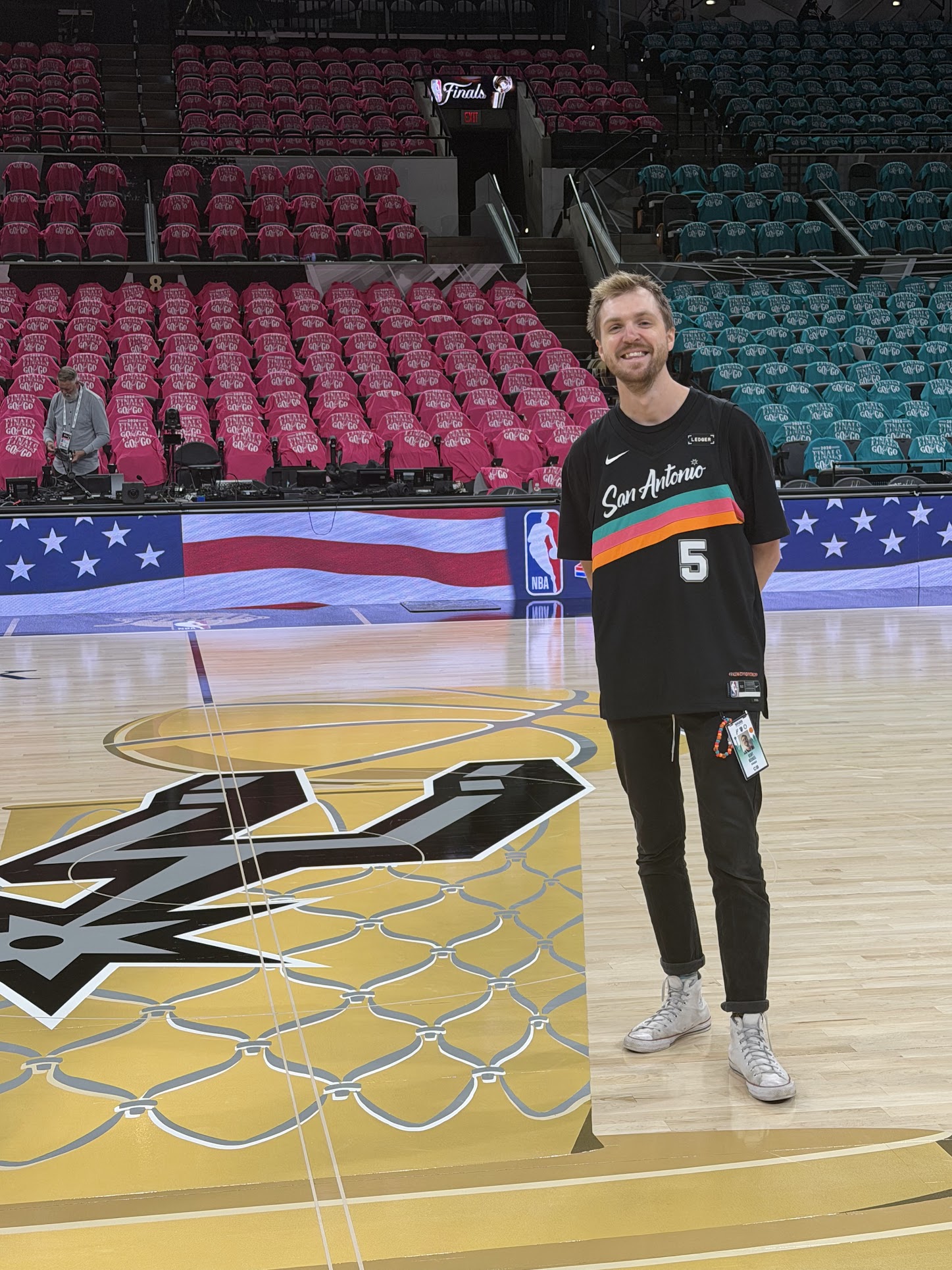 Kent working courtside at the NBA Finals in a San Antonio jersey